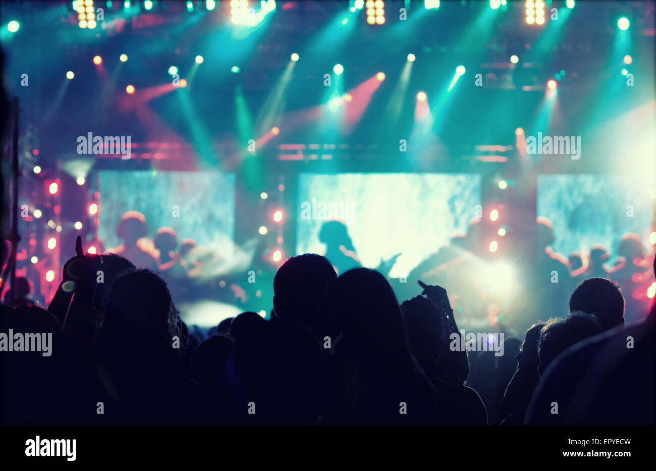 Cheering crowd in front of bright colorful stage lights - retro styled ...