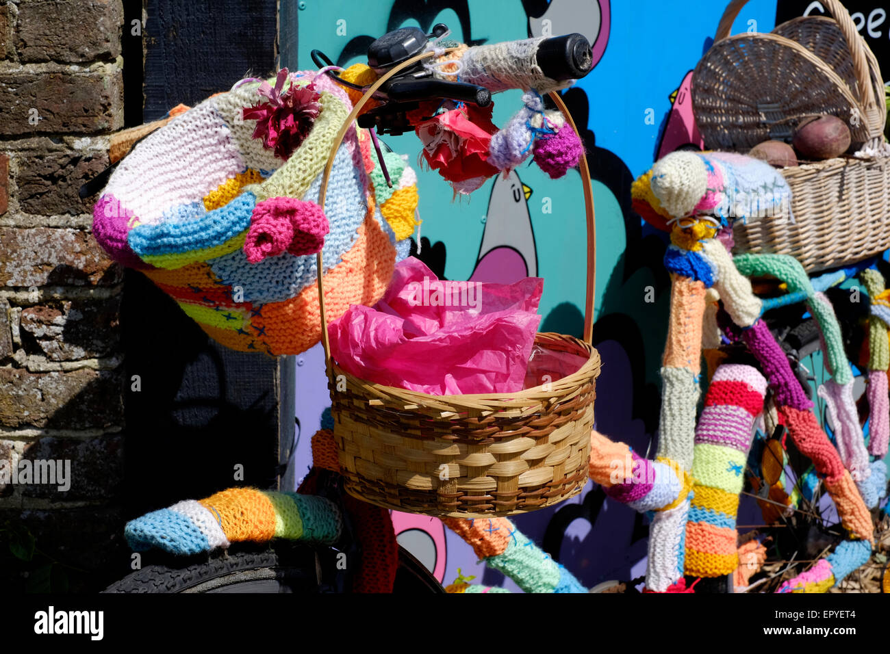 a colourful bicycle that has been yarn bombed Stock Photo