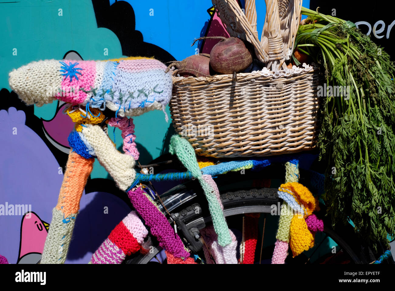 a colourful bicycle that has been yarn bombed Stock Photo