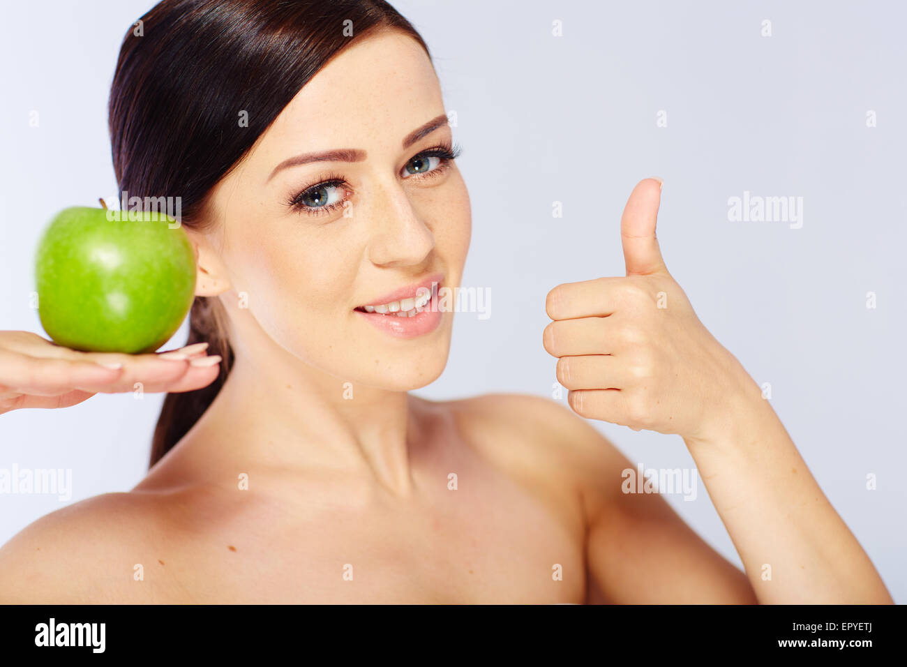 woman with a green apple Stock Photo