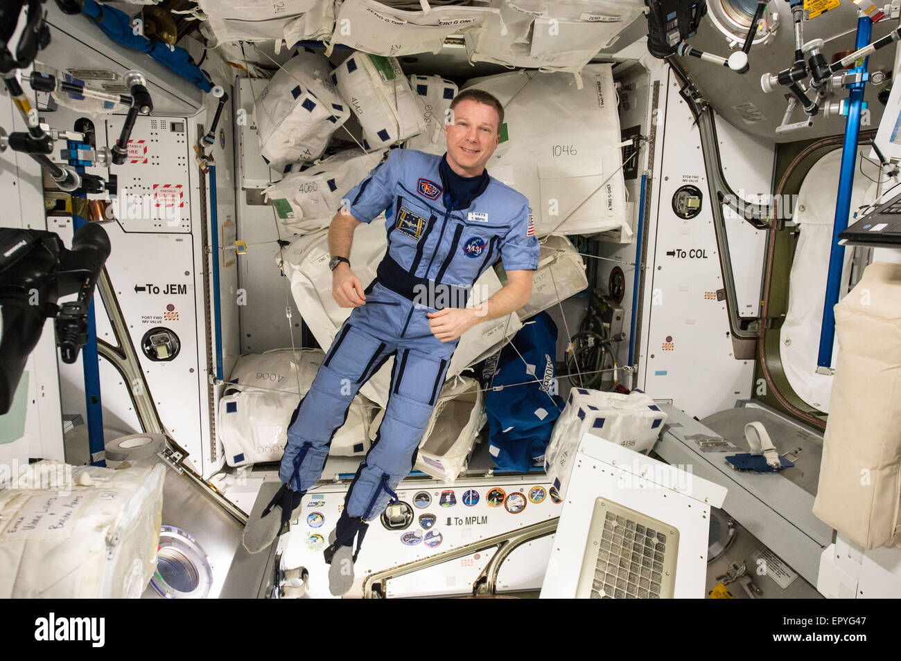 Expedition 43 commander and NASA astronaut Terry Virts floats around in a Penguin compression suit aboard the International Space Station May 12, 2015 in Earth Orbit. The suit prepares an astronaut's body to return to gravity. Stock Photo