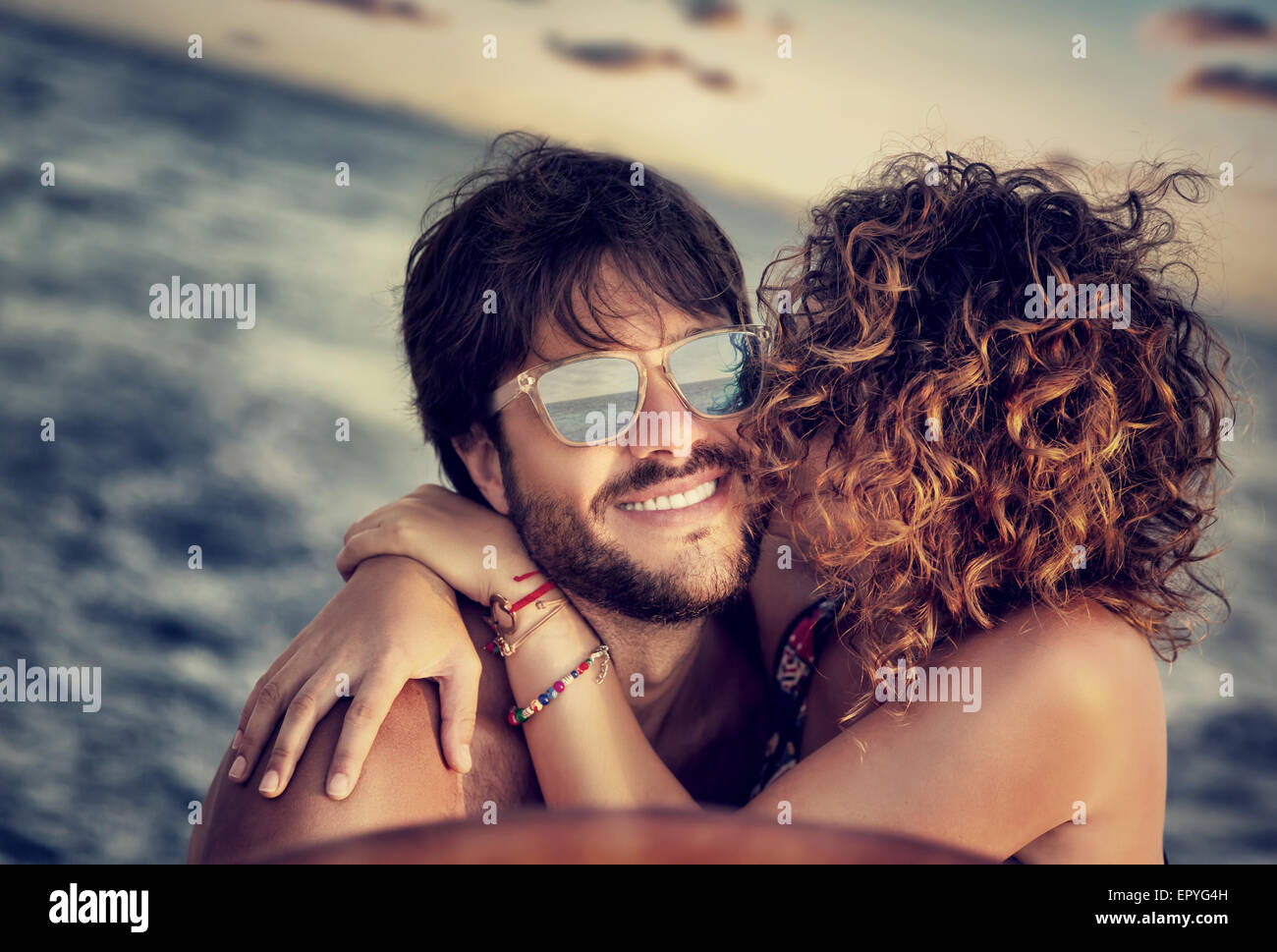 Closeup portrait of cheerful happy lovers on sailboat, young couple kissing and having fun in romantic cruise Stock Photo