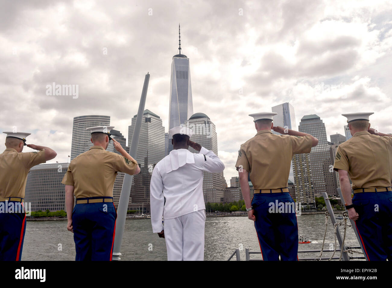 US Sailors and Marines man the rails an salute One World Trade Center in Manhattan during the Parade of Ships at Fleet Week May 20, 2015 in New York City, NY. Stock Photo