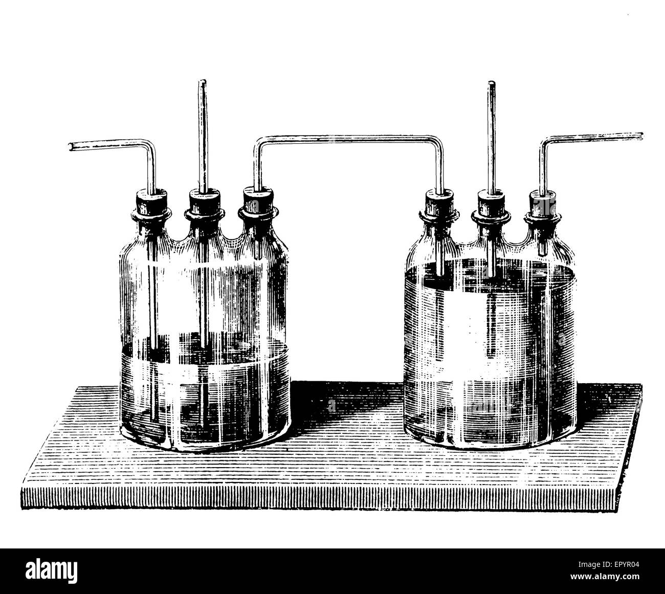 Vintage chemistry, a set of Woulff bottles, commonly used to prevent liquids from entering vacuum pumps, or to channel gases through liquids, trapping hazardous substances and preventing pressure buildup. Stock Photo