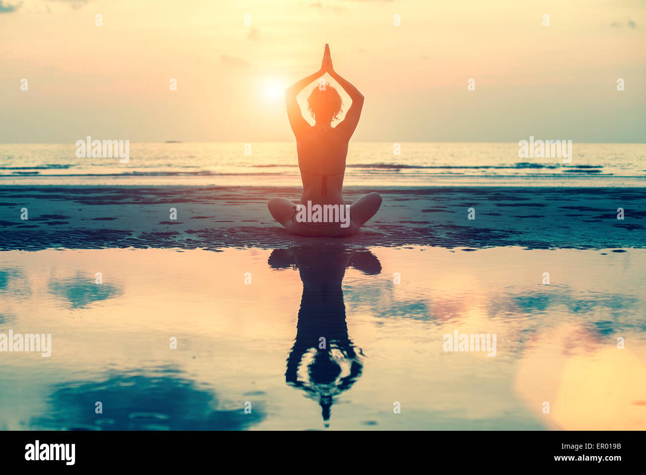 Silhouette of a beautiful yoga woman at sunset in surreal colors Stock ...