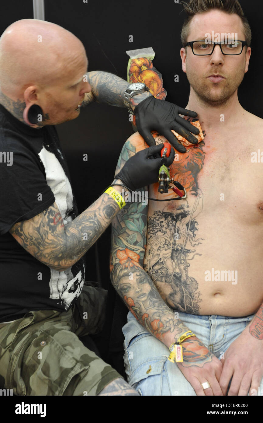 A man getting a tattoo at The Great British Tattoo Show, a prestigious body  art convention being held at Alexandra Palace, London. The show had 249 tattoo  artists from all around the
