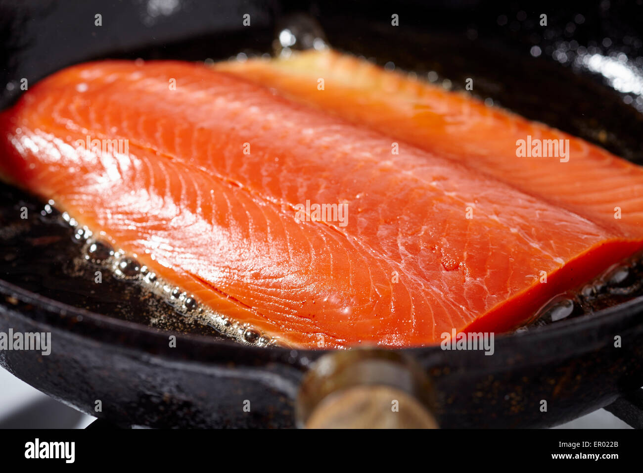 salmon fillet browning in a cast iron skillet Stock Photo Alamy