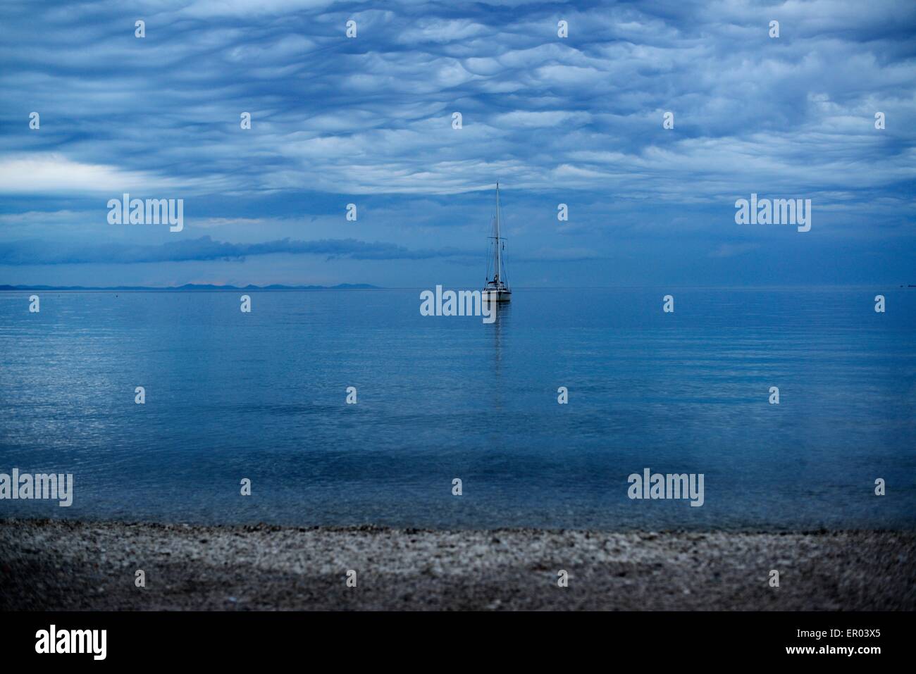 Sail boat in dawn (cloudy Stock Photo - Alamy