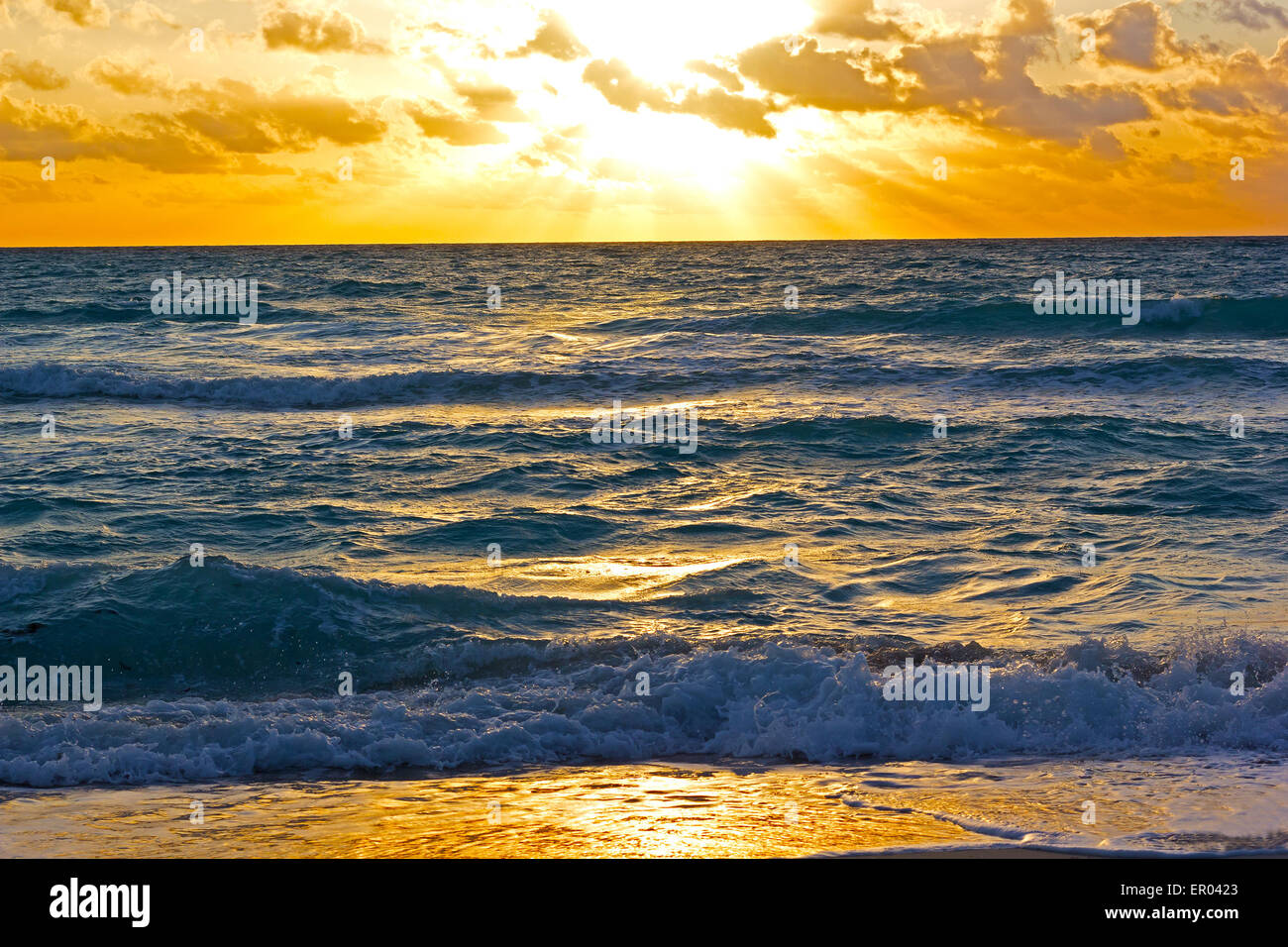 Sunrise reflection on the beach sand. Stock Photo