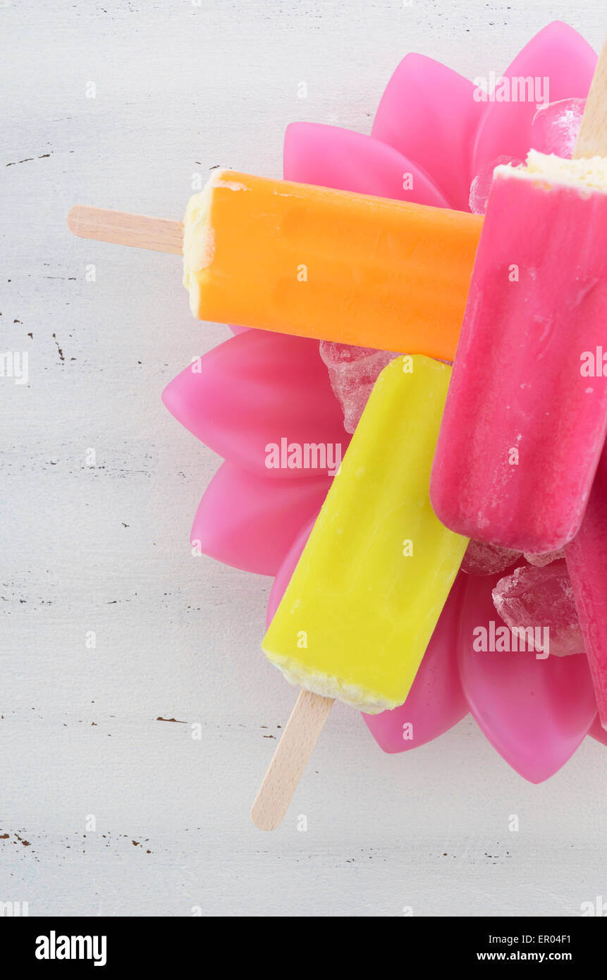 Summer is Here concept with bright color ice pop, ice creams on ice in