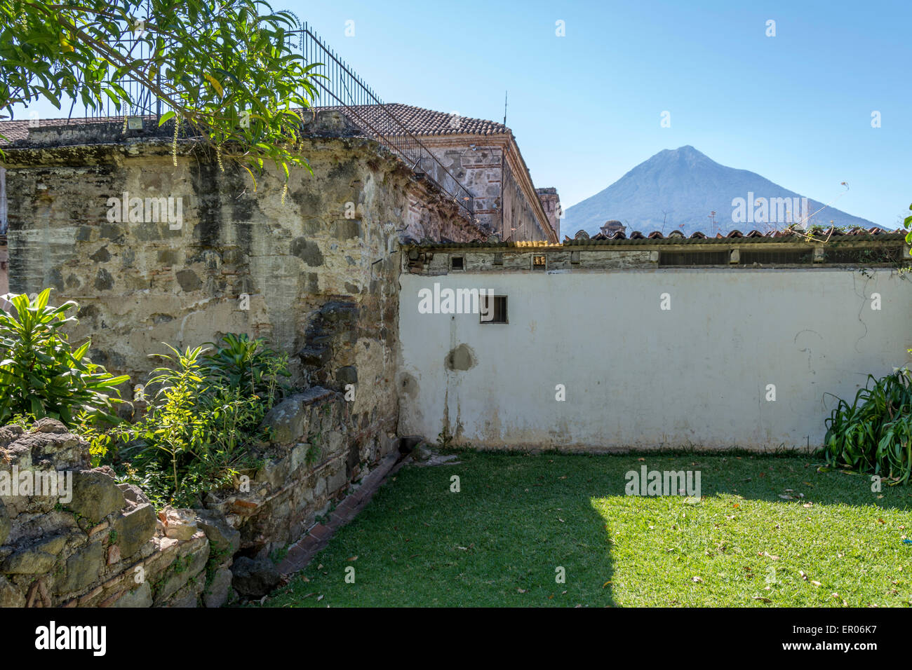 Garden area of Convento de las Capuchinas or Capuchinas Convent in Antigua Guatemala with Volcan Aqua in the background. Stock Photo