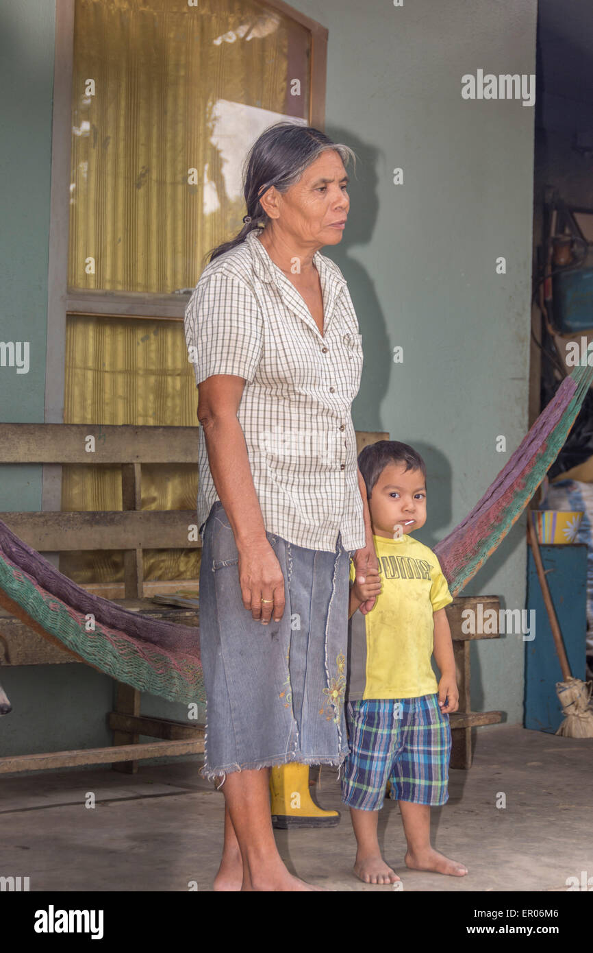Mother and child standing on the front porch of their home in Guatemala Stock Photo