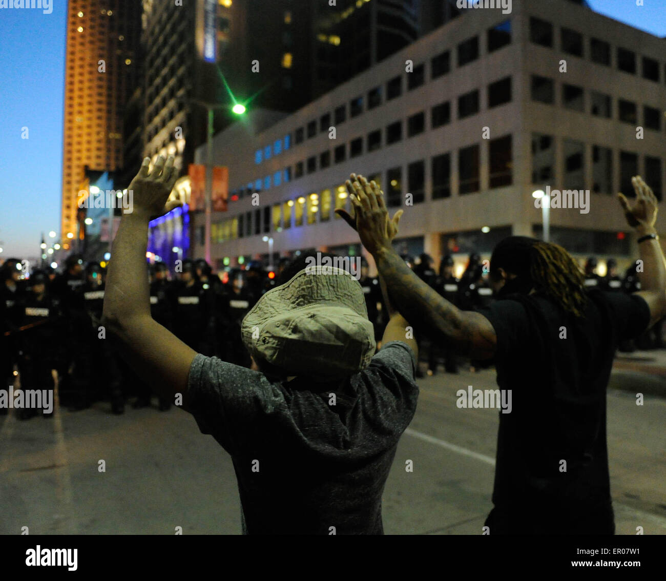 Cleveland, USA. 23rd May, 2015. Protesters hold up their hands before police in Cleveland, Ohio, the United States, May 23, 2015. Shortly after a white police officer in the U.S. state of Ohio was found not guilty in the killing of an unarmed black man and woman after a 22-mile car chase in November 2012, U.S. Justice Department announced that it would review the case. Credit: Bao Dandan/Xinhua/Alamy Live News Stock Photo