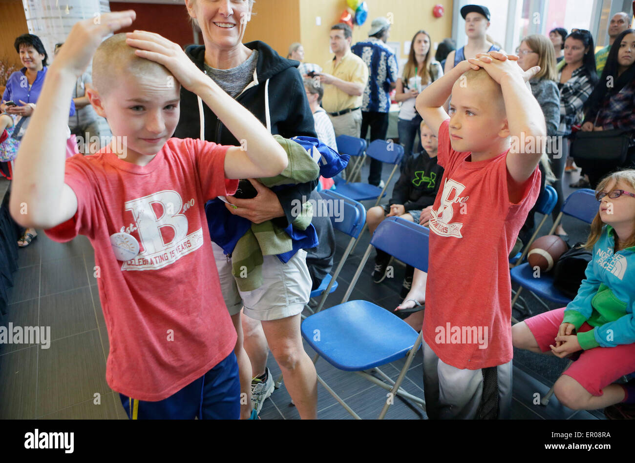 Vancouver, Canada. 23rd May, 2015. Young participants touch their bald
