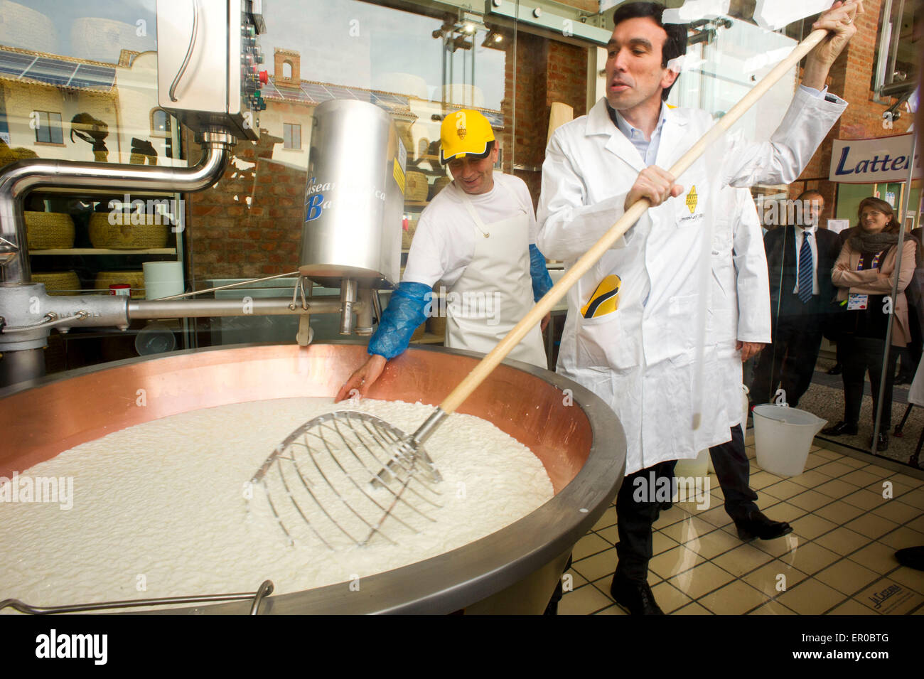 Italy Milan Expo 2015, the Italian Minister Maurizio Martina collaborated on the production of a form of Grana Padano Stock Photo