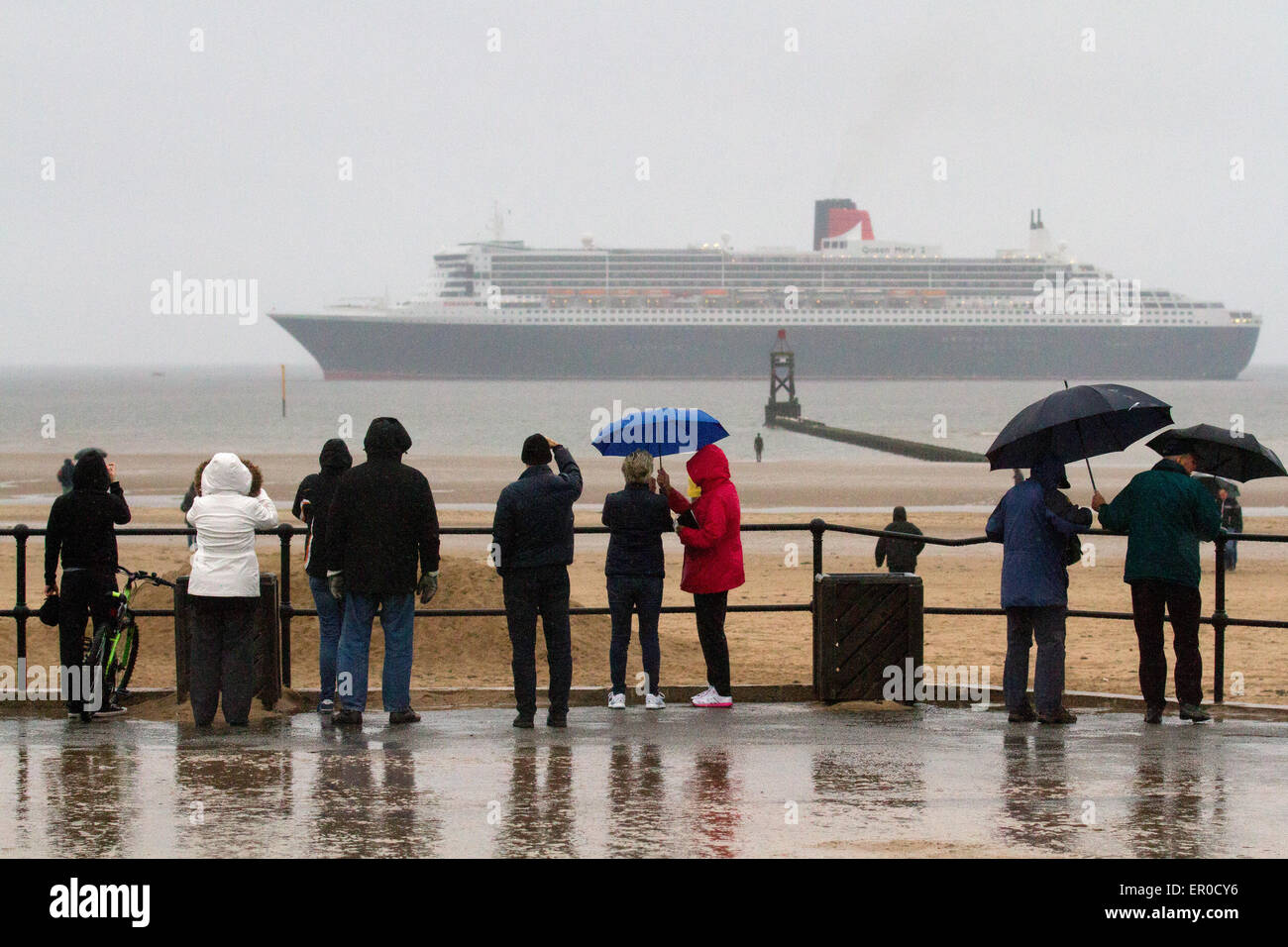 Liverpool, Merseyside, UK 24th May, 2015.  Cunard Queen Mary's arrival at dawn off Crosby Beach heralding the start of a stunning Three Queens celebration in the city. The flagship is the first of the company's three of luxury liners to arrive at Liverpool ahead of this Monday's celebrations which are expected to attract up to a million spectators. She will be joined by her two sister ships Queen Victoria and Queen Elizabeth in the following 24 hours for a sail past the city’s own three Queens to mark Cunard’s 175th birthday.  Credit:  Mar Photographics/Alamy Live News Stock Photo