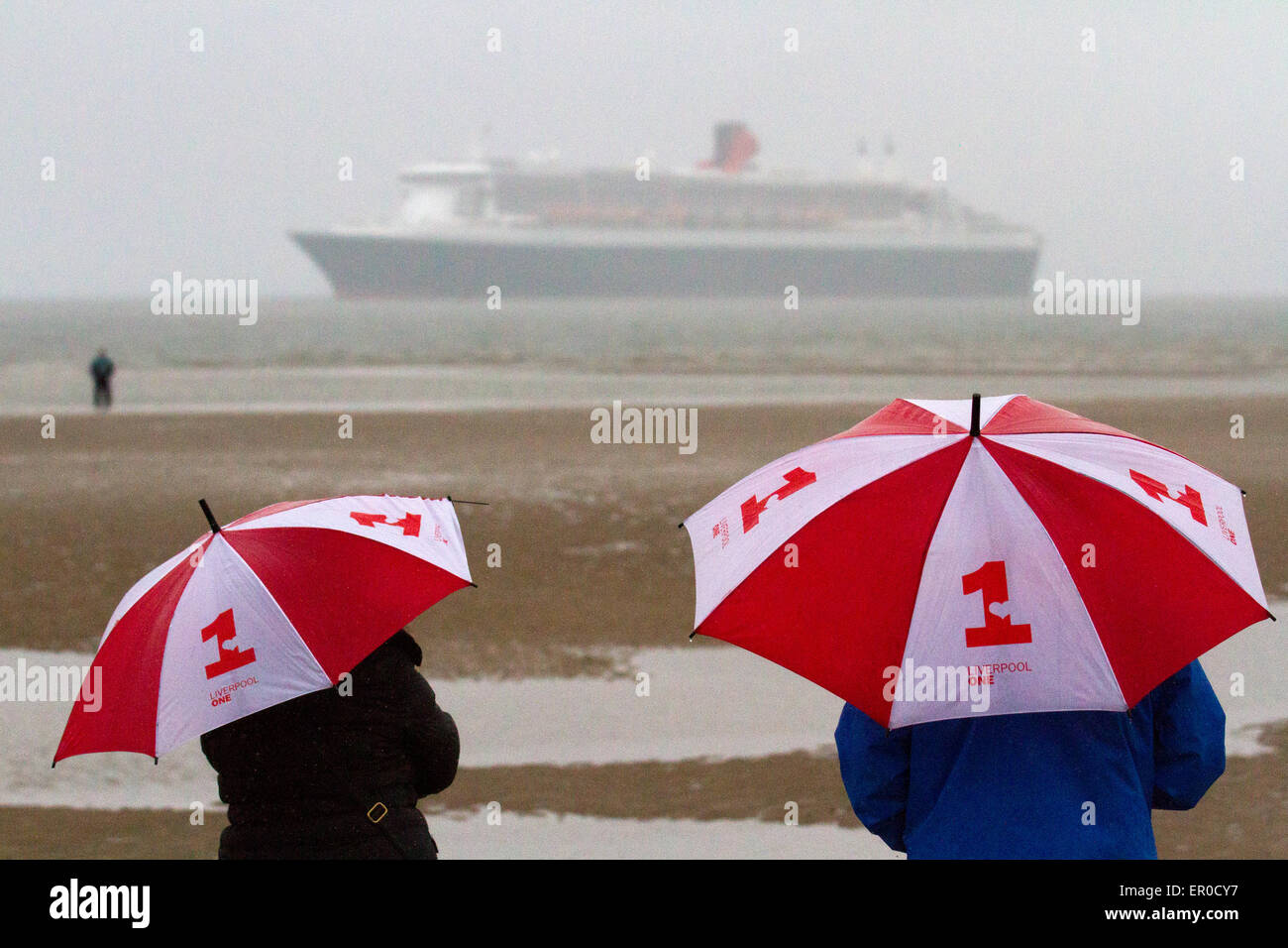 Golf umbrella, giant umbrellas in Liverpool, Merseyside, UK 24th May, 2015.  Cunard Queen Mary's arrival at dawn off Crosby Beach heralding the start of a stunning Three Queens celebration in the city. The flagship is the first of the company's three of luxury liners to arrive at Liverpool ahead of this Monday's celebrations which are expected to attract up to a million spectators. She will be joined by her two sister ships Queen Victoria and Queen Elizabeth in the following 24 hours for a sail past the city’s own three Queens to mark Cunard’s 175th birthday. Stock Photo