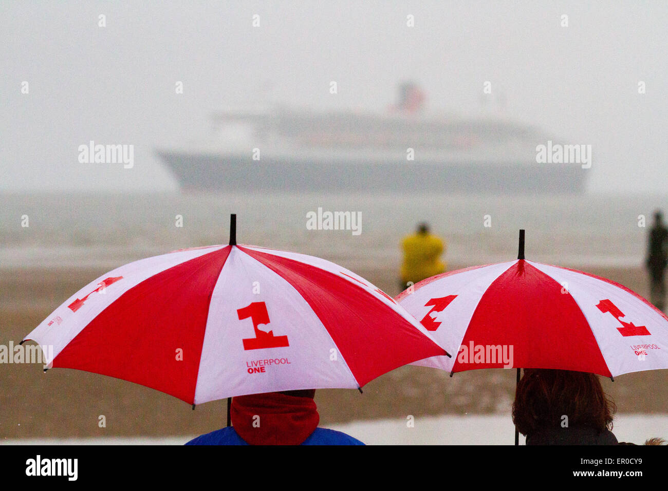 Golf umbrella, giant umbrellas in Liverpool, Merseyside, UK 24th May, 2015.  Cunard Queen Mary's arrival at dawn off Crosby Beach heralding the start of a stunning Three Queens celebration in the city. The flagship is the first of the company's three of luxury liners to arrive at Liverpool ahead of this Monday's celebrations which are expected to attract up to a million spectators. She will be joined by her two sister ships Queen Victoria and Queen Elizabeth in the following 24 hours for a sail past the city’s own three Queens to mark Cunard’s 175th birthday. Stock Photo