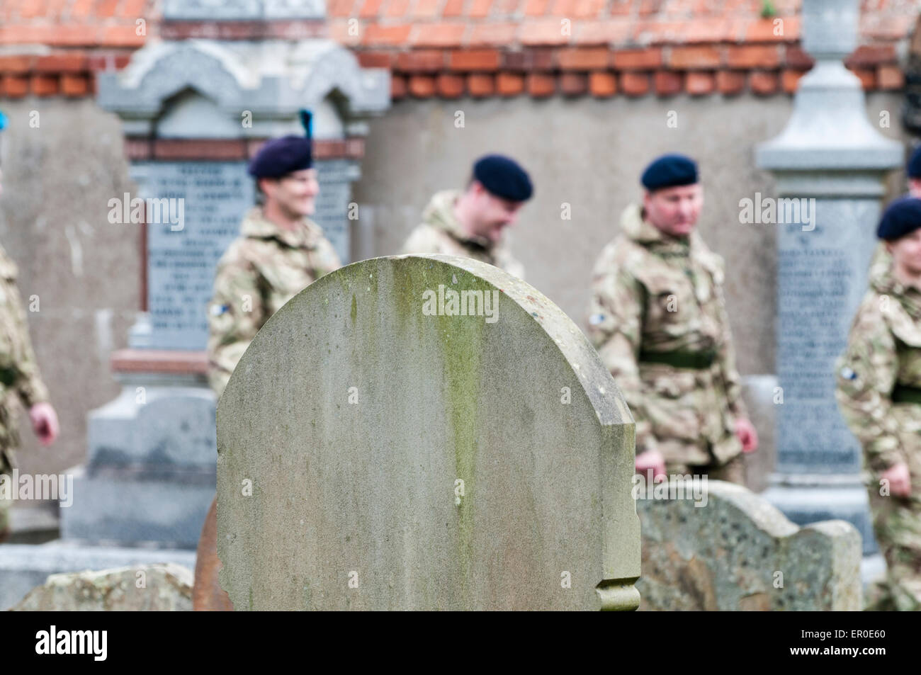 Carrickfergus, Northern Ireland. 23rd May, 2015. Soldiers walk among gravestones in a graveyard Credit:  Stephen Barnes/Alamy Live News Stock Photo