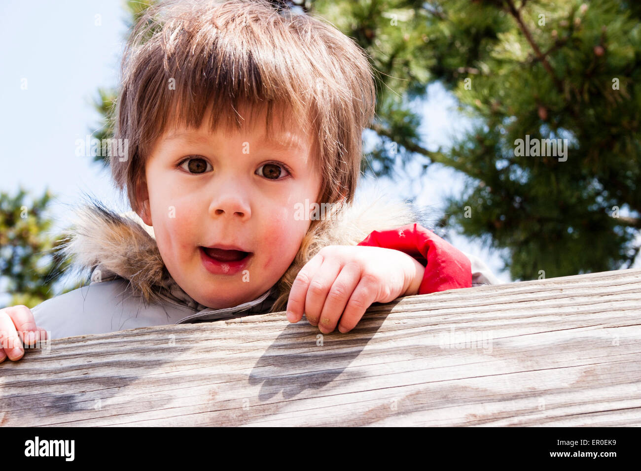 Head and shoulder shot of young child, boy, 34 year old, with red