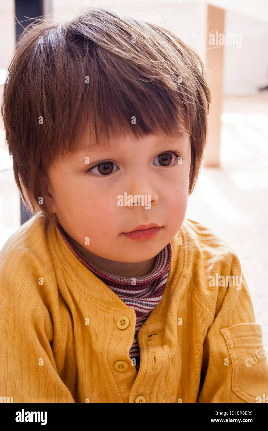 Close up head and shoulders of young child, boy, 3-4 year old, looking  forward with a very thoughtful expression. Angelic face with big eyes Stock  Photo - Alamy