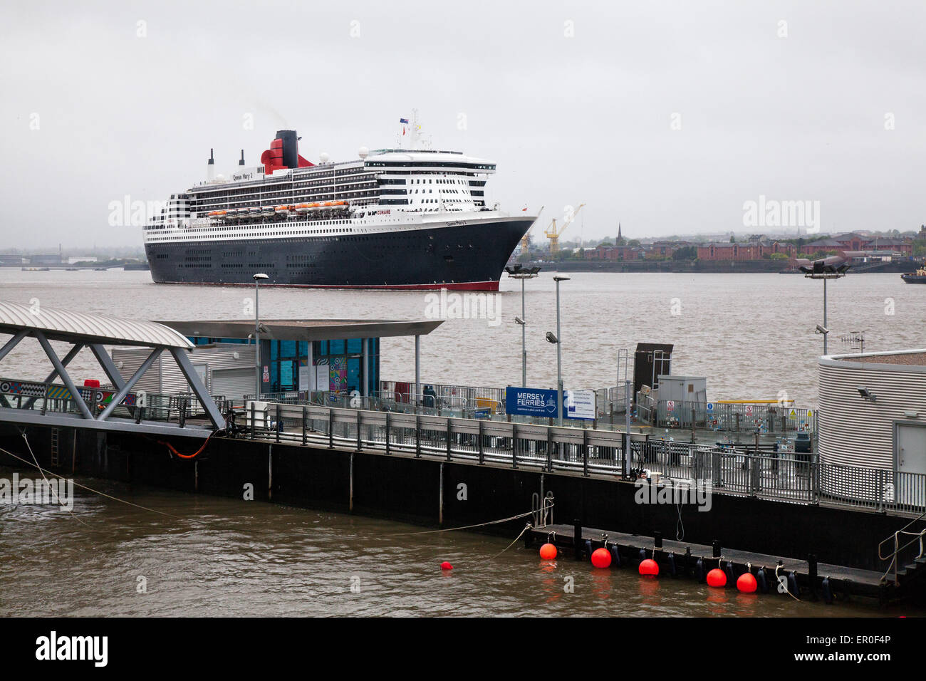 Liverpool, Merseyside, UK 24th May, 2015.  Cunard Queen Mary arrival at dawn at Princes Dock Cruise Terminal. The flagship is the first of the company's three of luxury liners to arrive at Liverpool ahead of this Monday's celebrations which are expected to attract up to a million spectators. She will be joined by her two sister ships Queen Victoria and Queen Elizabeth in the following 24 hours for a sail past the city’s own three Queens to mark Cunard’s 175th birthday. Stock Photo