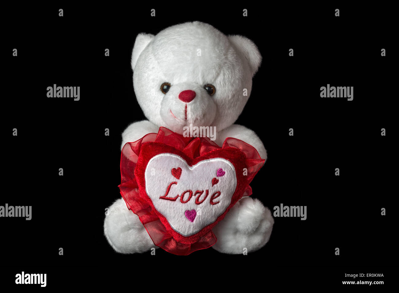 White teddy bear isolated on black background. Stock Photo