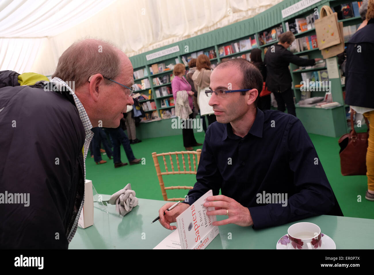 Powys, Wales, UK May 2015 Author Yuval Noah Harari in the Festival bookshop signing copies of his latest book Sapiens - A Brief History of Humankind. Stock Photo