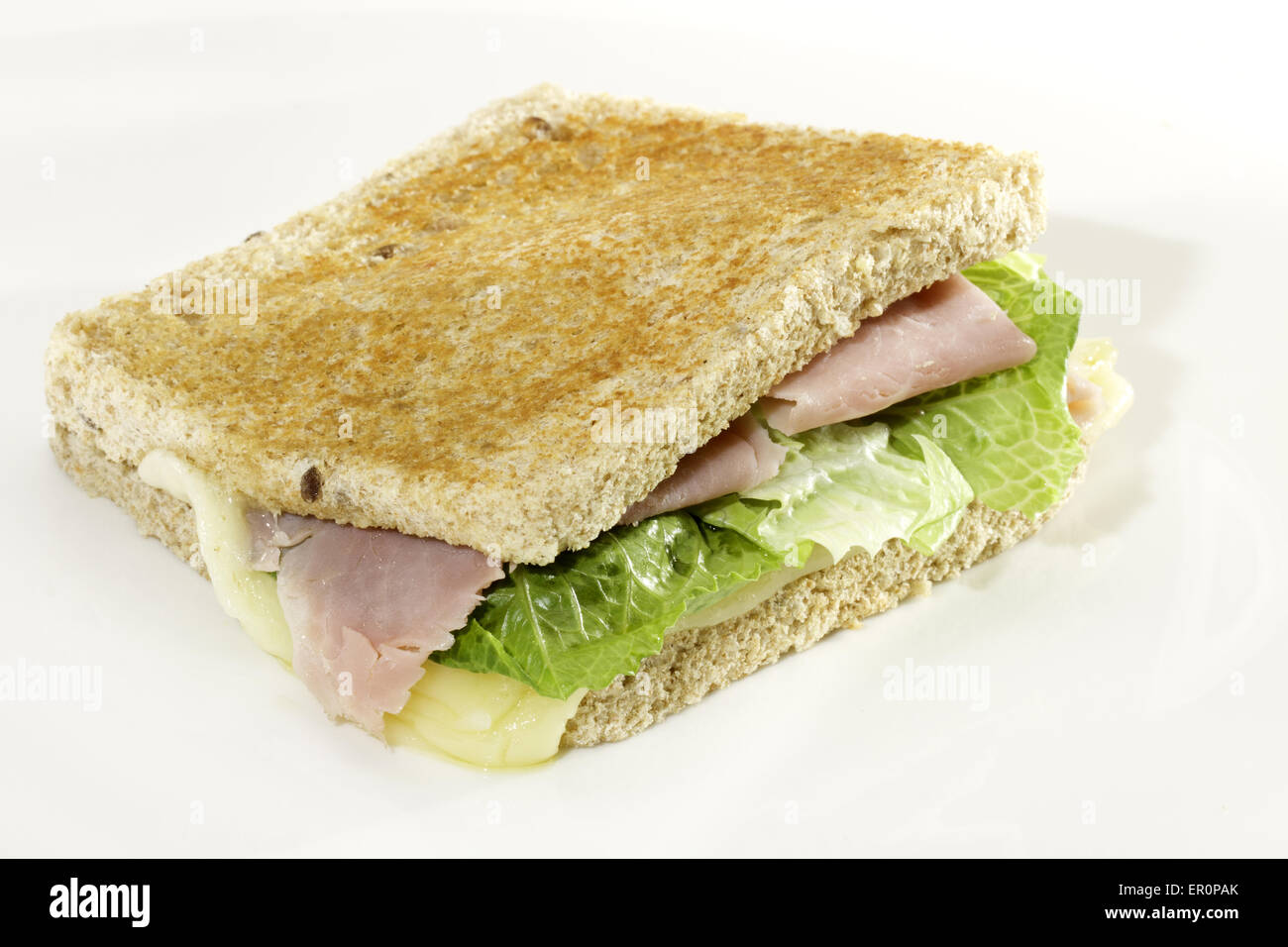 Toast sandwich with ham, melted cheese and lettuce Stock Photo