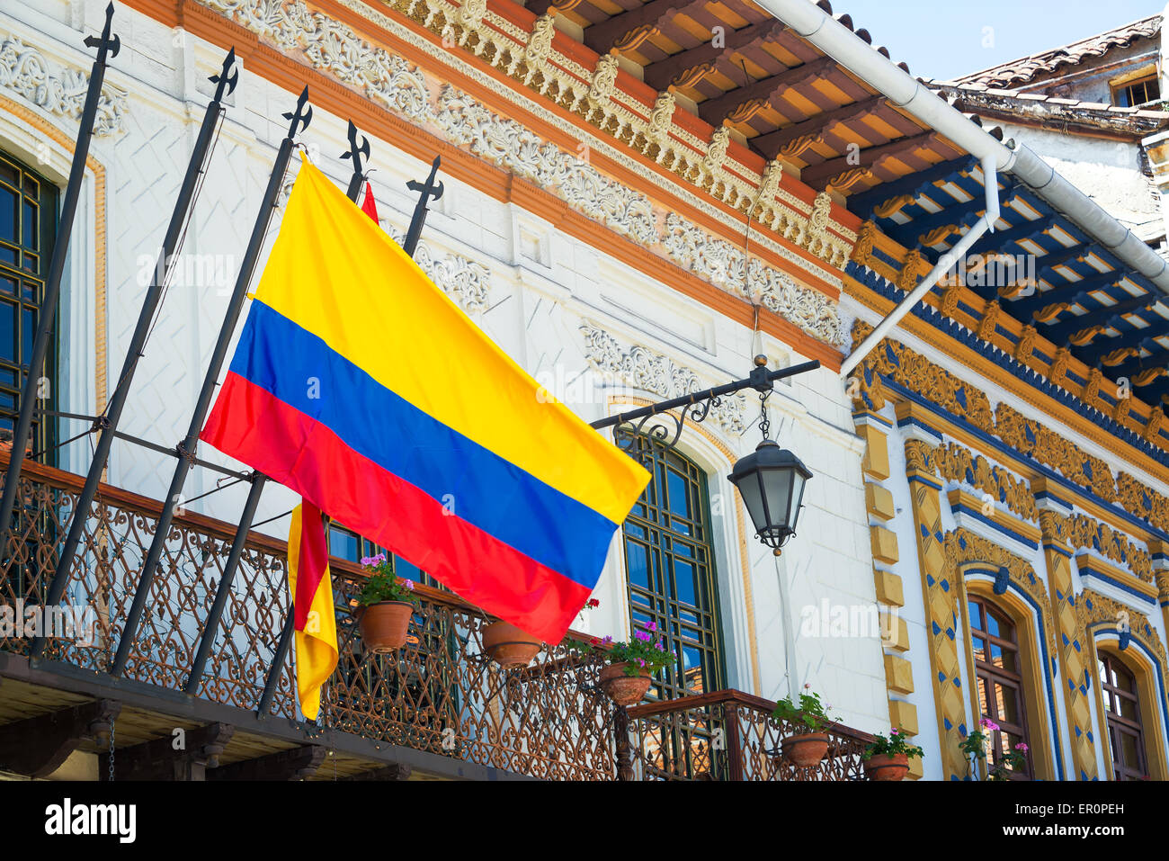 Historic buildings in Cuenca, Ecuador with a Ecuadorian flag in the foreground Stock Photo