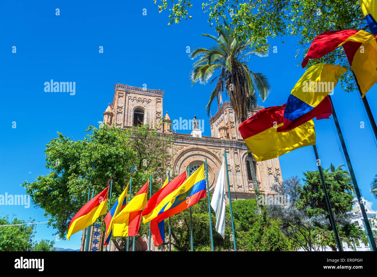 Flags waving in front of the cathedral in the historic center of Cuenca, Ecuador Stock Photo