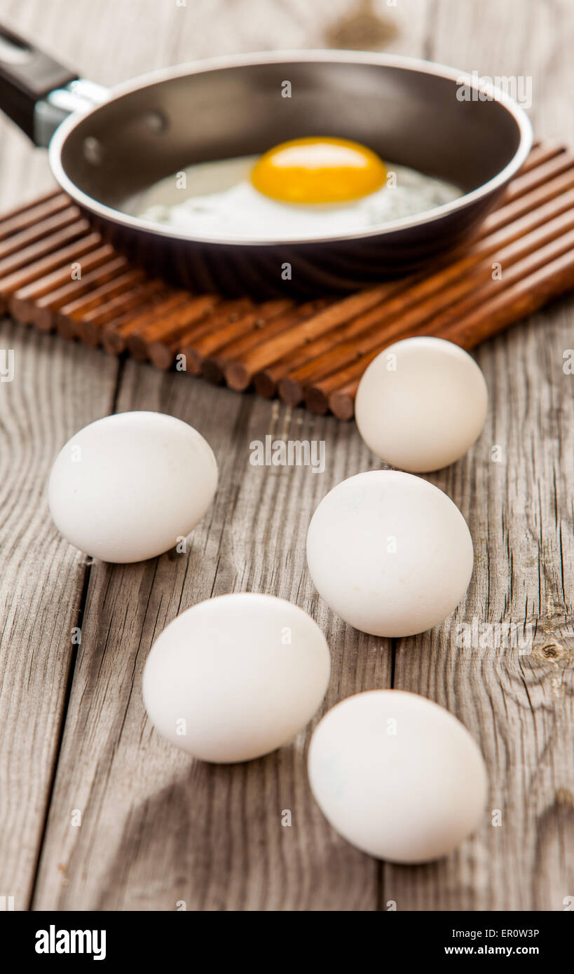 Fried eggs on a wooden table, breakfast Stock Photo