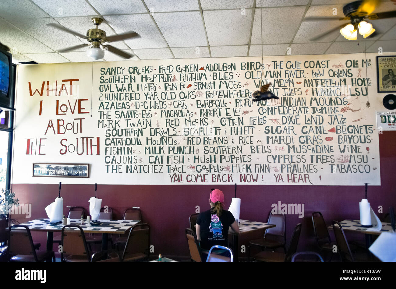 A list of attractions of the Old South are painted on a wall at the Pig Out Inn, a casual dining spot known for its BBQ in Natchez, Mississippi, USA. Stock Photo
