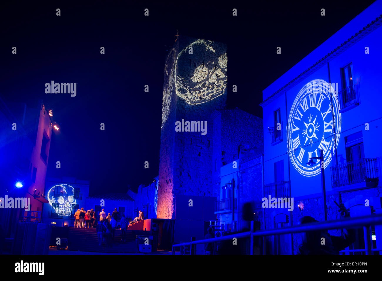 Light projection of a skull over medieval city as part of the feast setup. Stock Photo