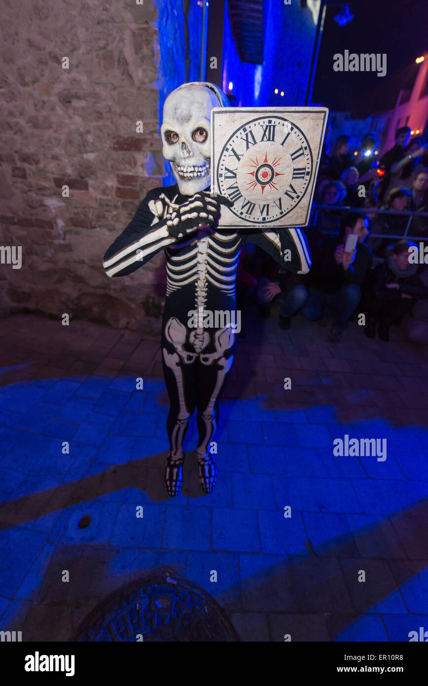 Dancing skeletons reminding the crowd about shorness of life. This is the main scene of the Dance of the Dead in Verges, Spain,  Stock Photo