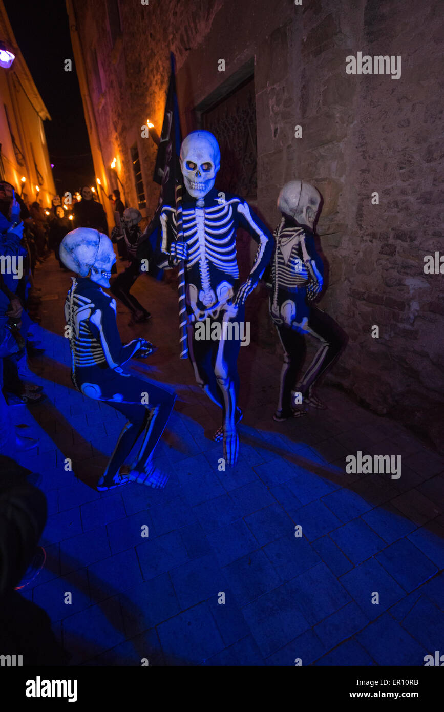 Dancing skeletons reminding the crowd about shorness of life. This is the main scene of the Dance of the Dead in Verges, Spain,  Stock Photo