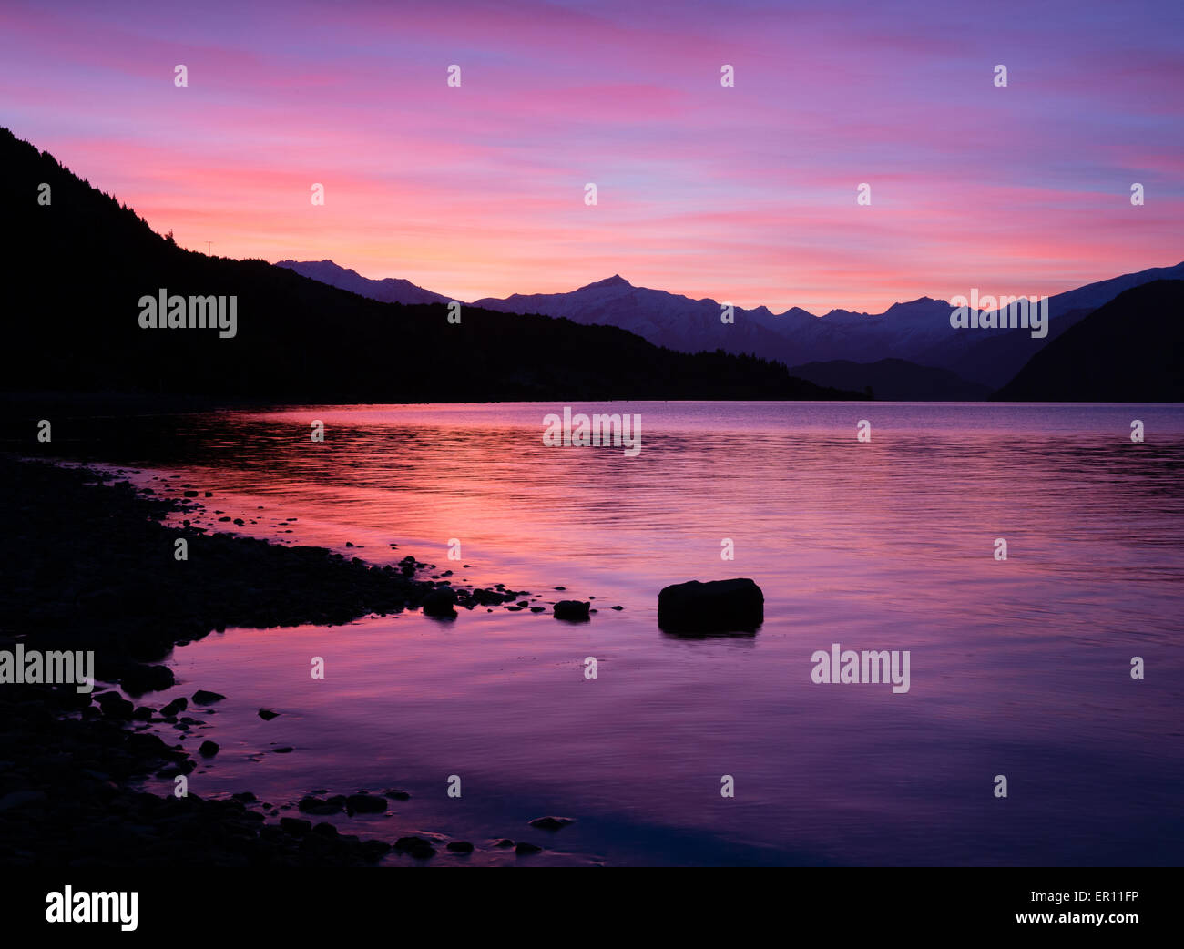 Lake Wanaka outlet at dusk with views towards the Aspiring Range in South Island New Zealand Stock Photo
