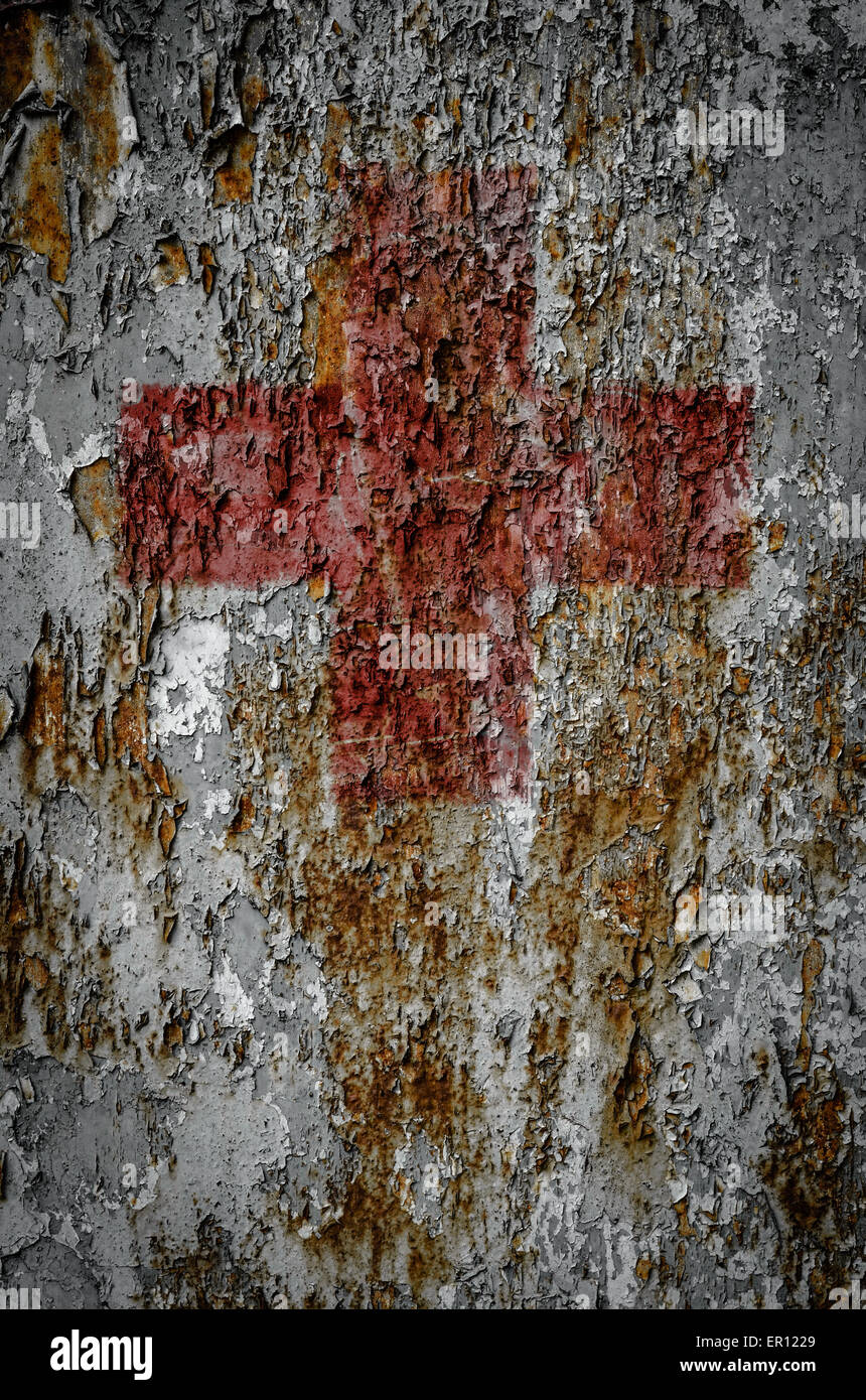 A First Aid Red Cross On A Grungy Rusty Texture Background Stock Photo
