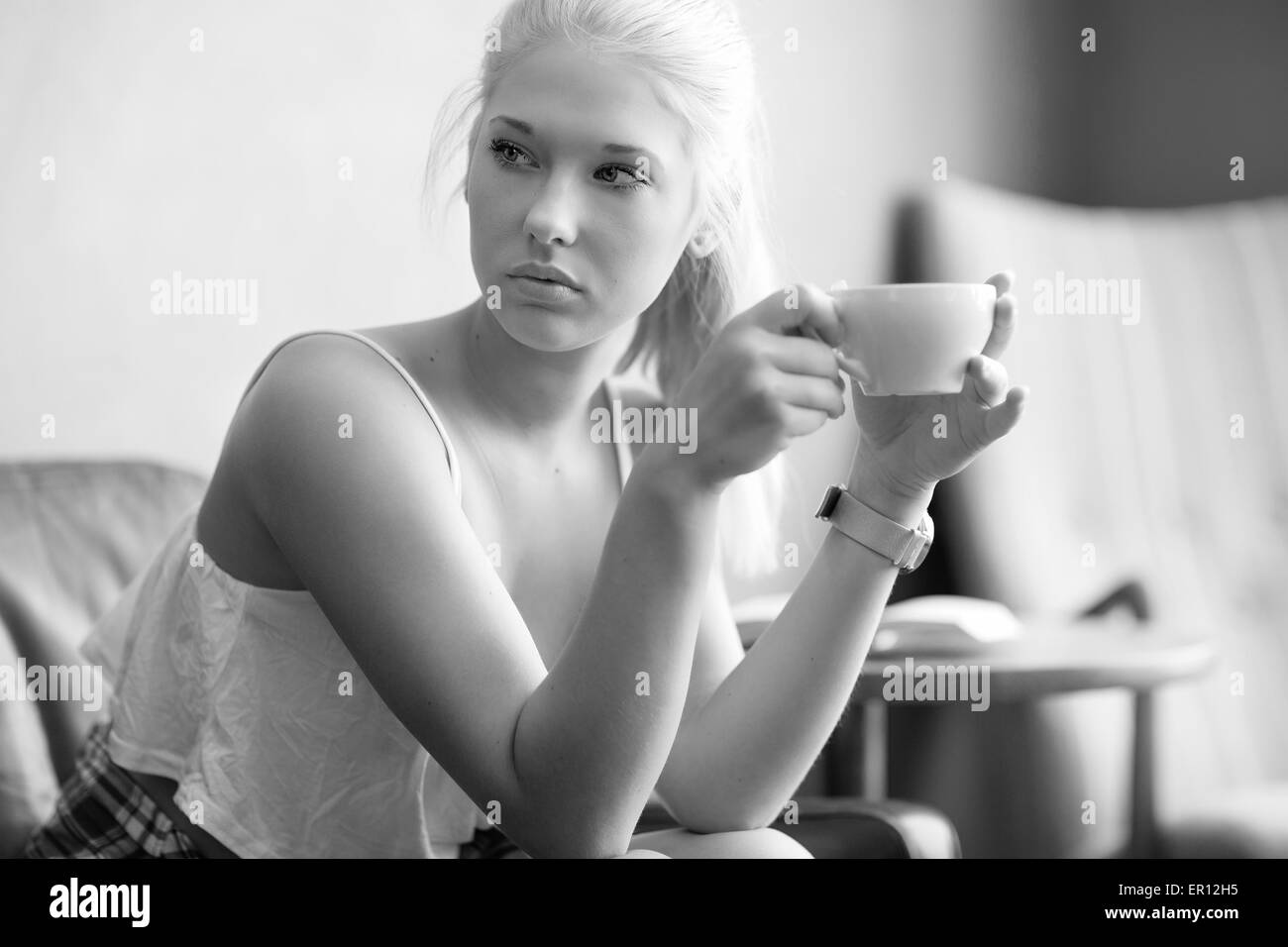 Young and pretty woman drinking coffee at cafe Stock Photo