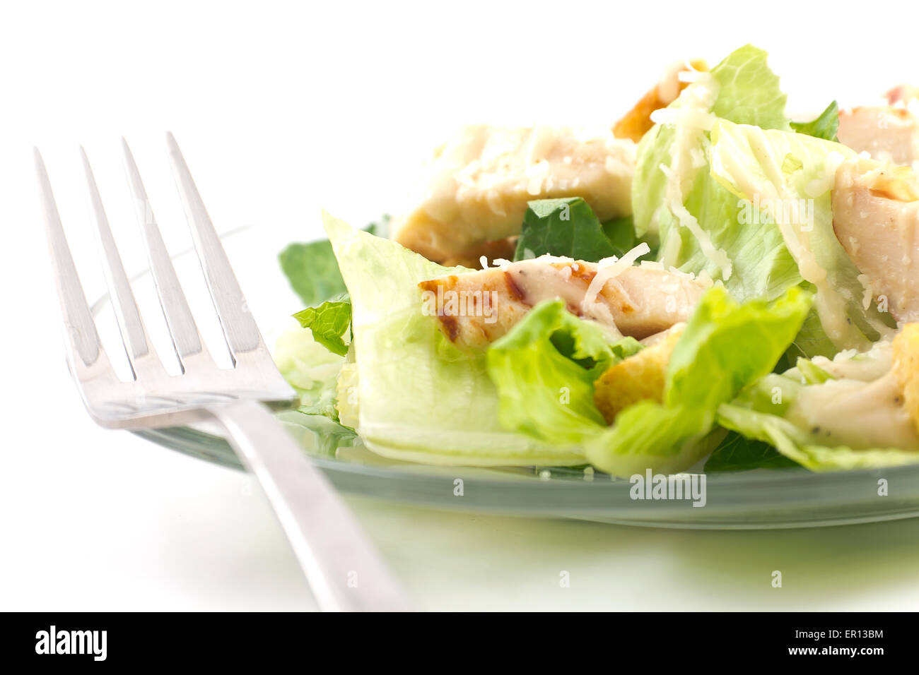 Chicken Caesar salad isolated on a white background with crutons and thick creamy dressing Stock Photo