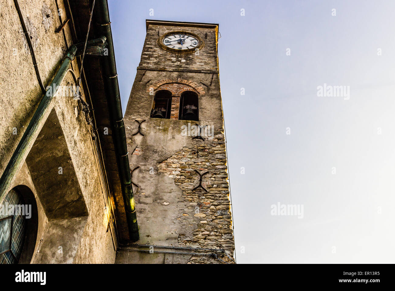 Medieval brickwall steeple of a country church in Emilia Romagna in the Northern Italy countryside. Clock at 17:40 Stock Photo
