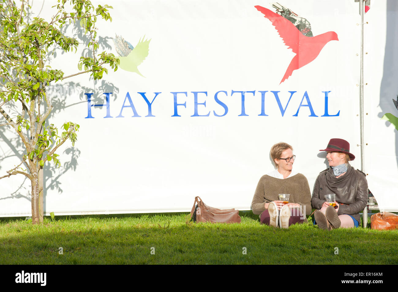 Hay-on-Wye, Powys, UK. 24th May 2015. Festival Goers relax in the evening sunshine. Credit:  Graham M. Lawrence/Alamy Live News. Stock Photo