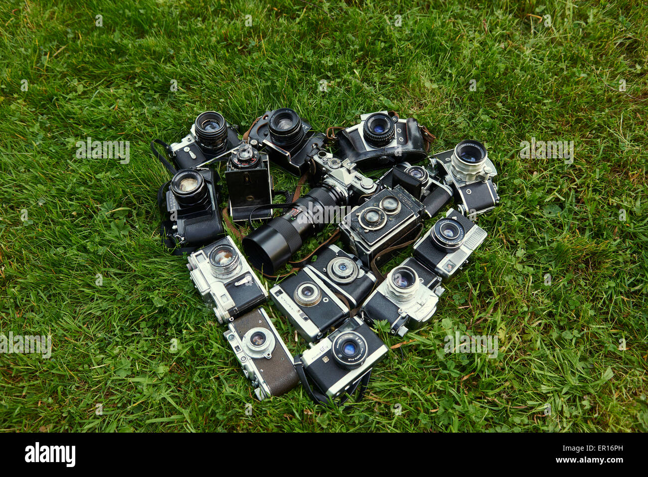 Heart shape made by collection of old retro film cameras, lying on ...