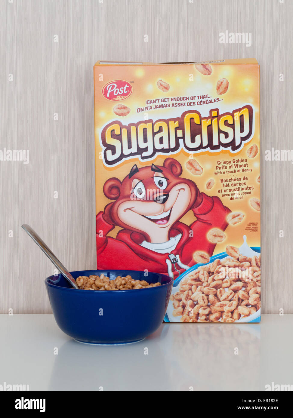 A box and bowl of Sugar Crisp (Golden Crisp), a breakfast cereal made by Post Cereals which consists of sweetened puffed wheat. Stock Photo