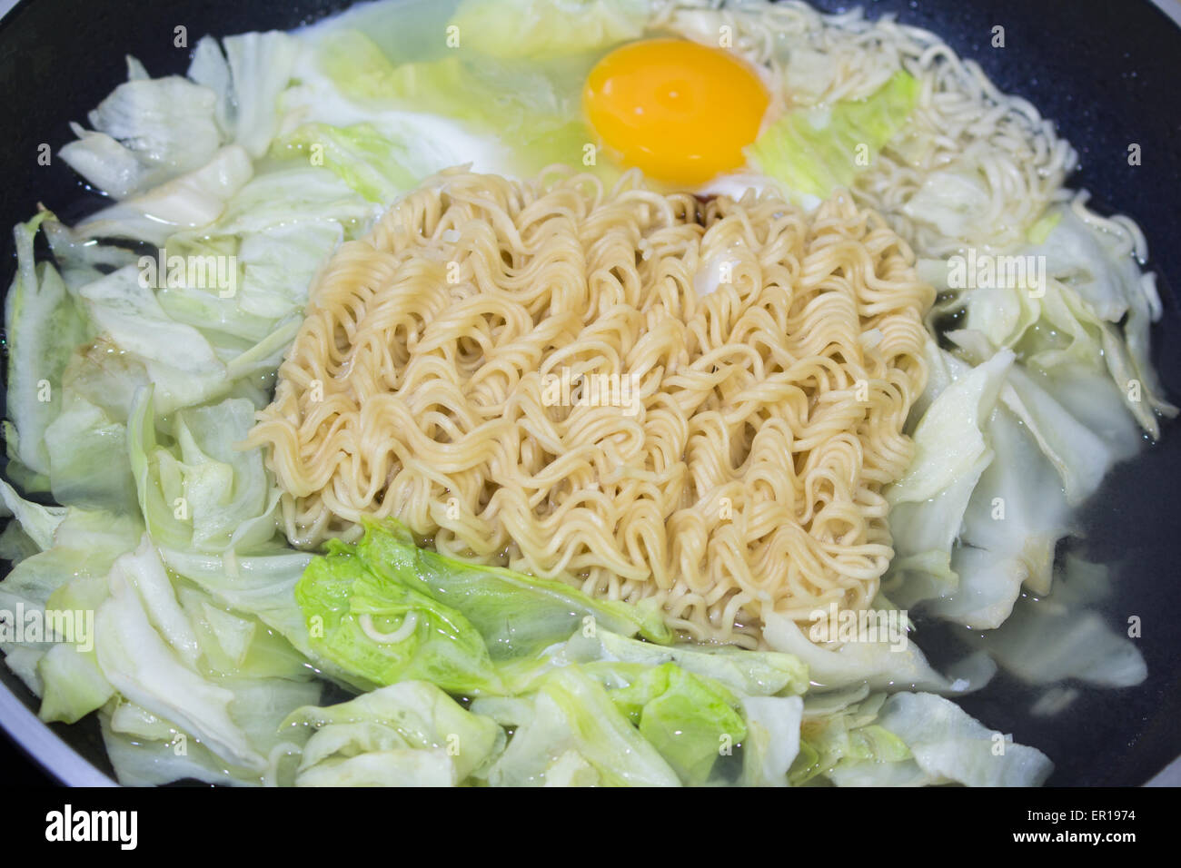 Cooking noodle and vegetable close up of boiling noodles in a pot Stock Photo