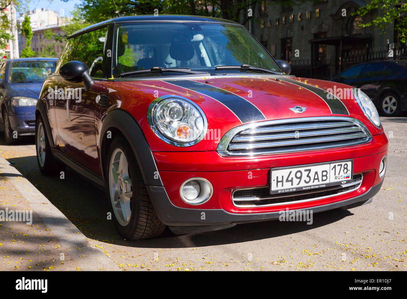 Saint-Petersburg, Russia - May 32, 2015: shining red metallic mini cooper car with black stripes stands on road side in the city Stock Photo