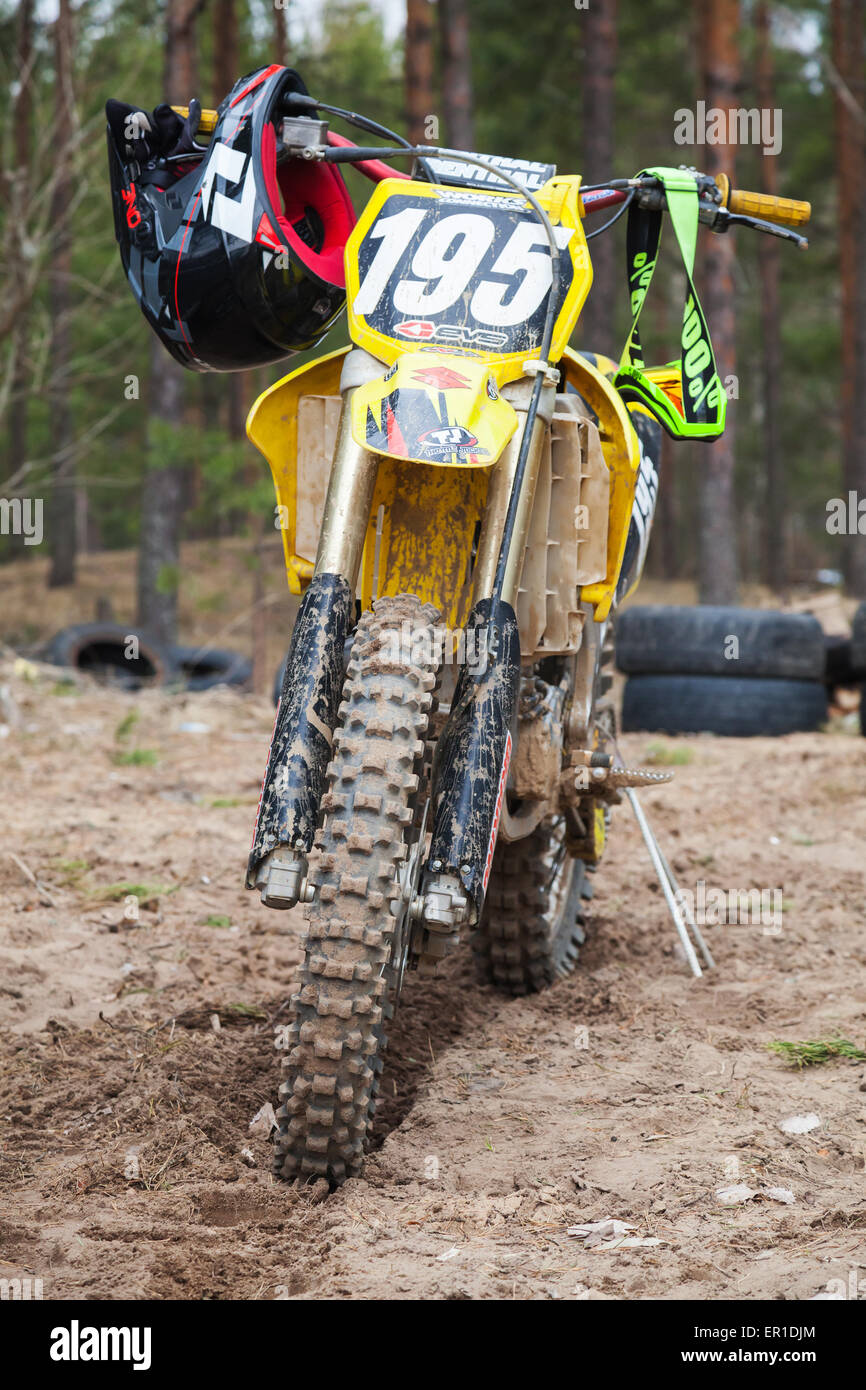 Saint-Petersburg, Russia - April 13, 2014: Yellow motocross bike stands on the dirty track road Stock Photo