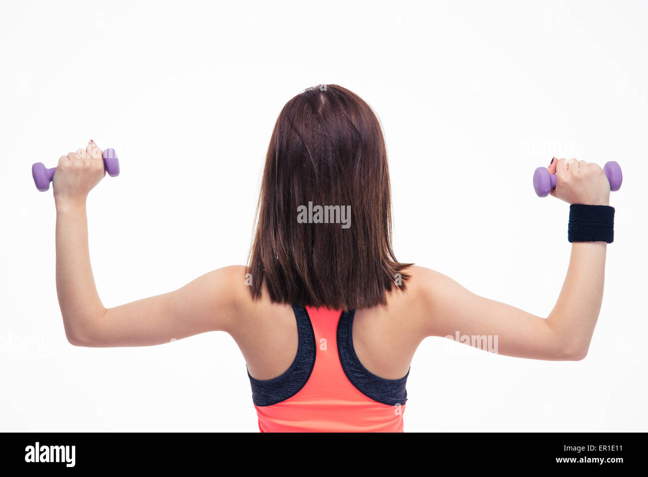 Back view portrait of a fitness woman working out with dumbbells isolated on a white backgorund Stock Photo
