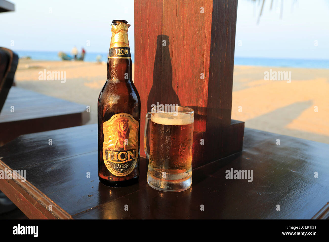 Close up of cold glass and bottle of Lion lager beer, Sri Lanka, Asia