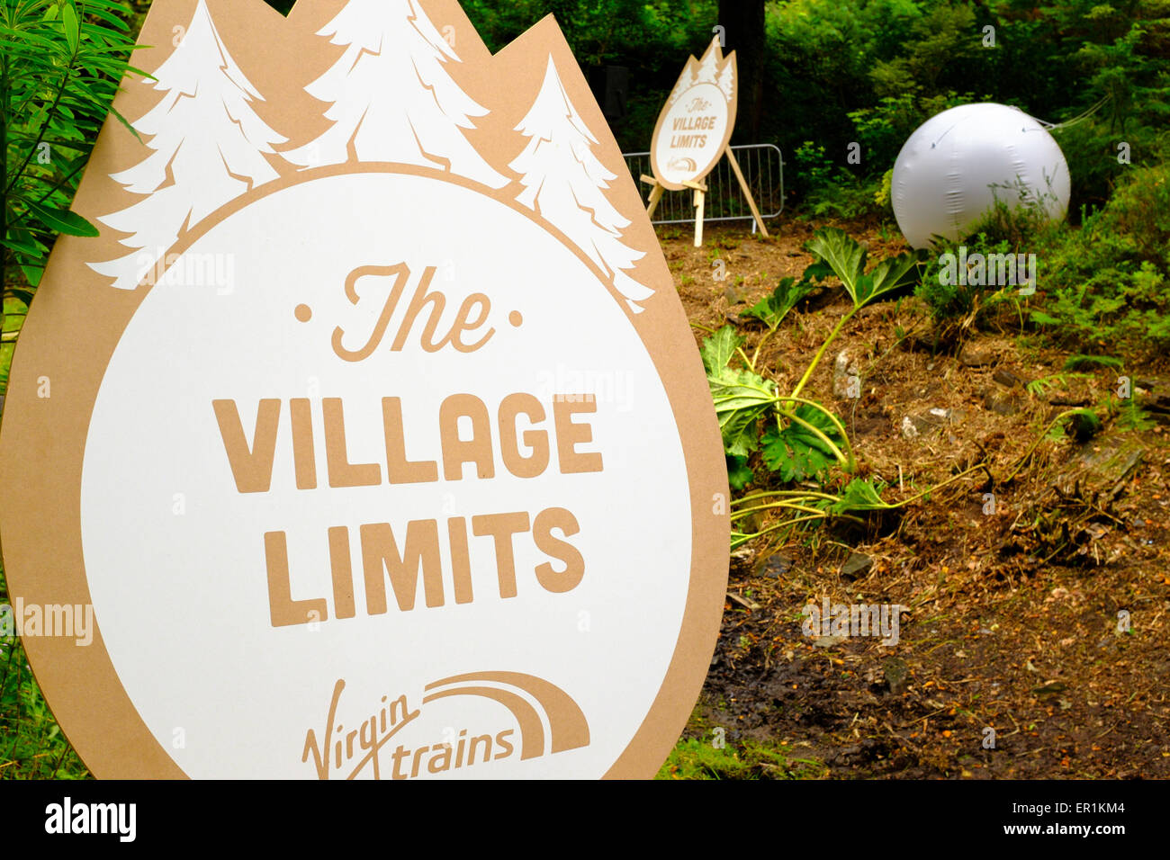 Virgin Trains sign, states 'The Village Limits' in the woods. During Festival No.6. In Portmeirion Stock Photo
